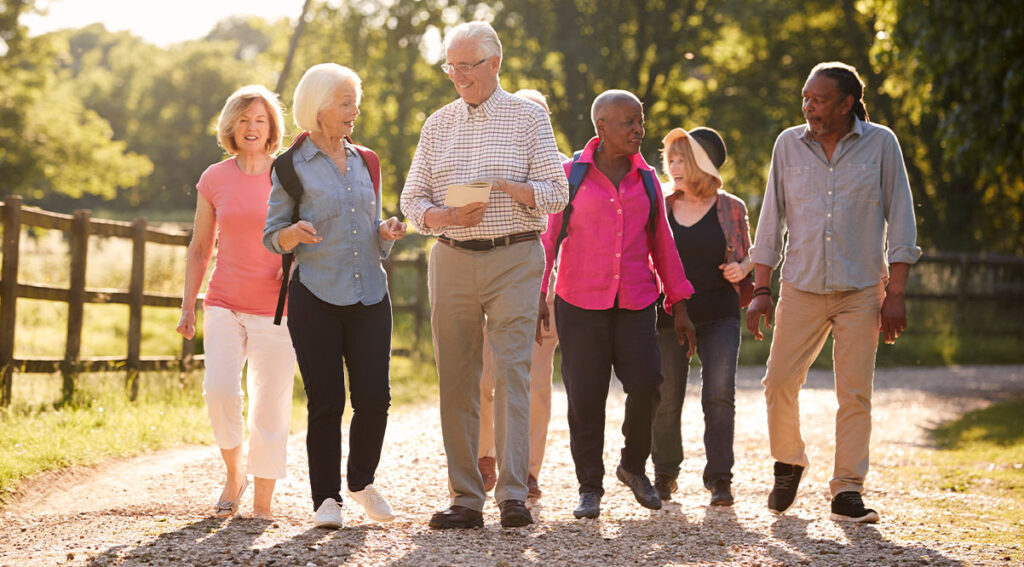 group of senior friends walking together outdoors planning for retirement